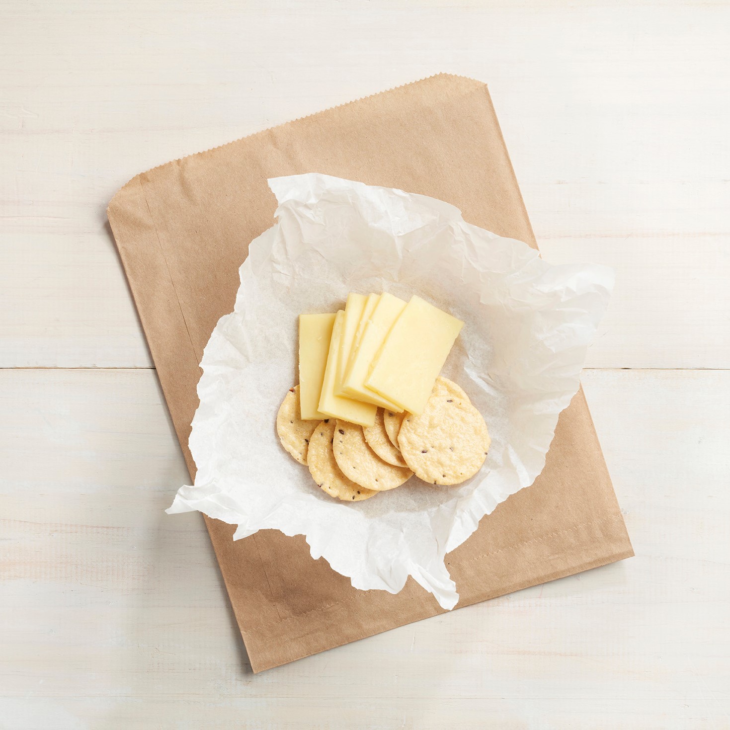 Cheese & crackers on brown paper