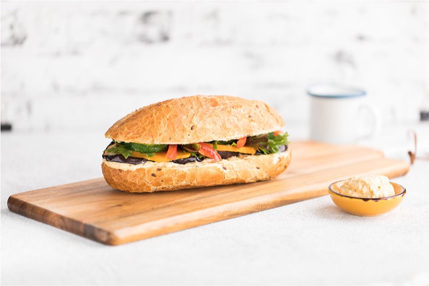 A sandwich on a wooden cutting board